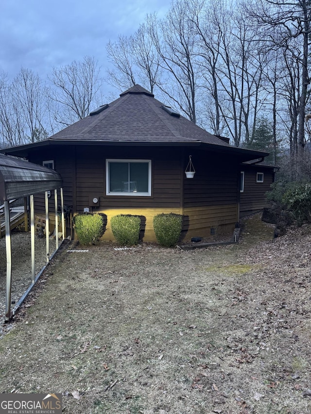 view of side of property featuring a carport