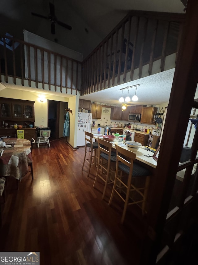 dining space featuring dark hardwood / wood-style flooring and ceiling fan