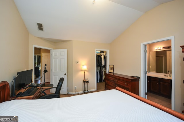 carpeted bedroom with vaulted ceiling, a spacious closet, ensuite bath, and a closet