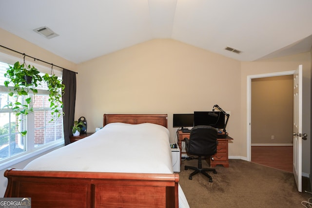 carpeted bedroom with lofted ceiling