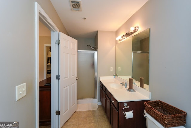 bathroom featuring vanity, tile patterned floors, and a shower with door