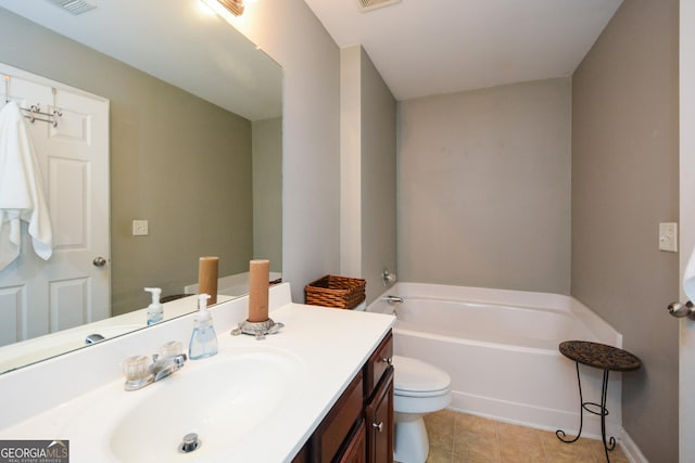 bathroom with vanity, a bath, and toilet