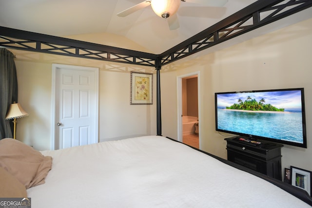 bedroom featuring ceiling fan, vaulted ceiling, and ensuite bath