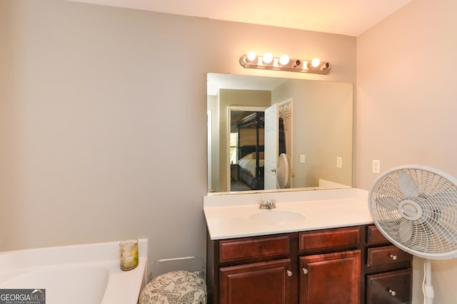 bathroom with vanity and a tub