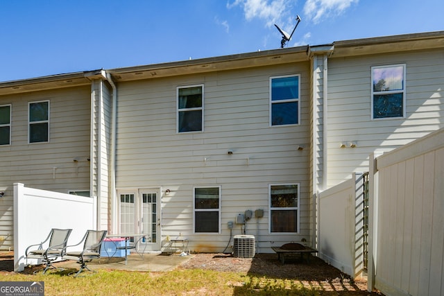 rear view of property with central AC and a patio area