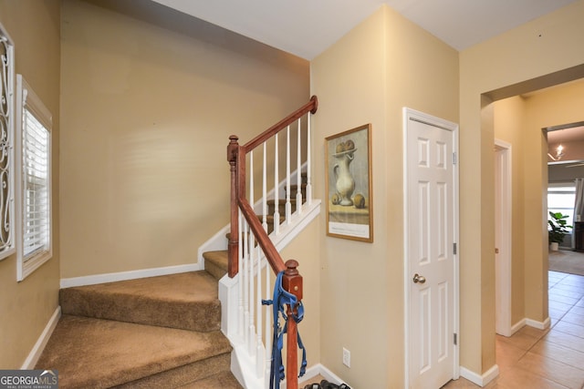 stairs with tile patterned flooring