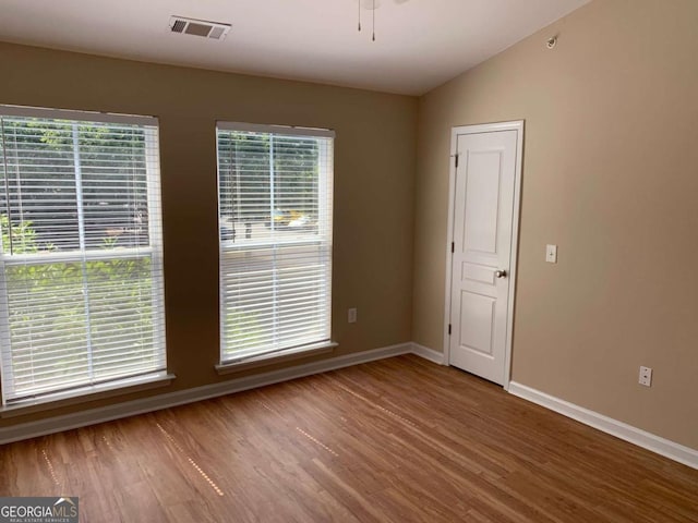 unfurnished room featuring hardwood / wood-style floors, vaulted ceiling, and ceiling fan