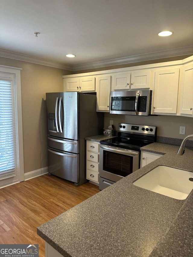 kitchen featuring white cabinetry, sink, plenty of natural light, and appliances with stainless steel finishes