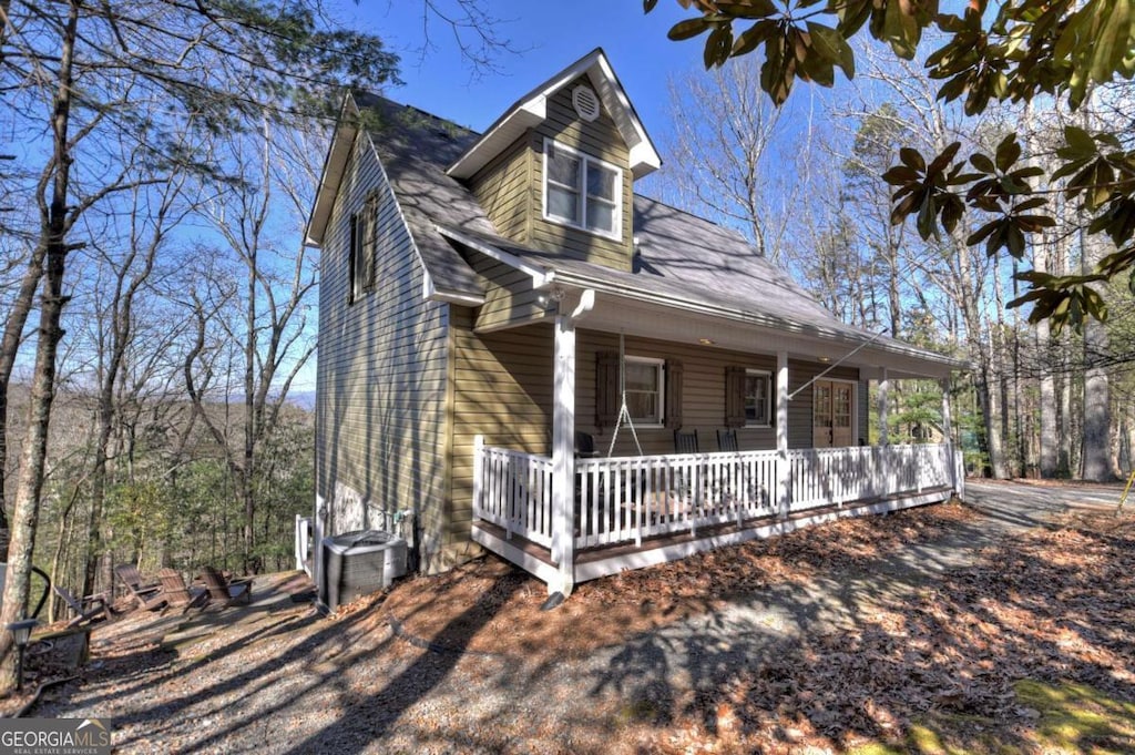 view of front of house with a porch and central air condition unit