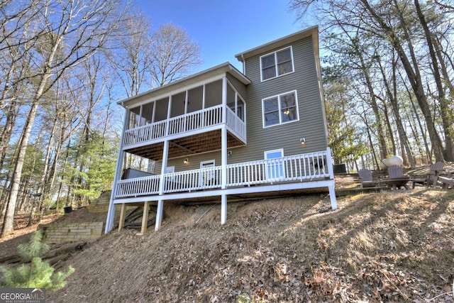 back of property with a sunroom