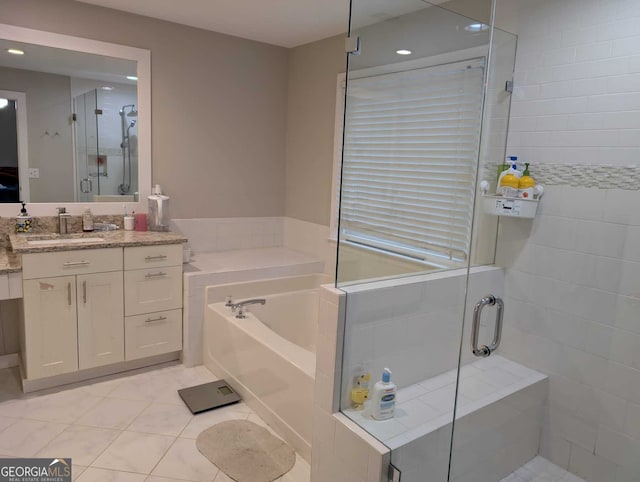 full bath featuring a stall shower, tile patterned floors, vanity, and a bath