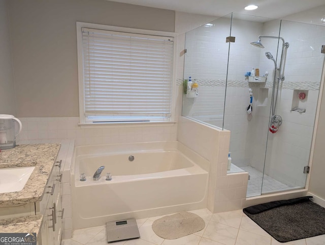 full bath featuring a stall shower, a garden tub, and vanity