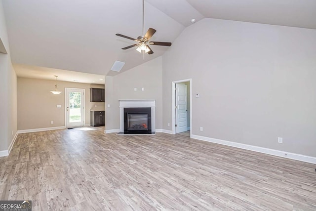 unfurnished living room with lofted ceiling, light hardwood / wood-style flooring, and ceiling fan