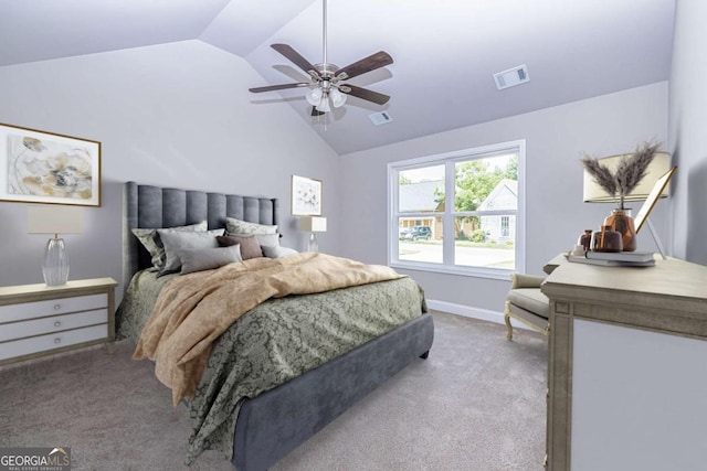 bedroom with vaulted ceiling, light colored carpet, and ceiling fan