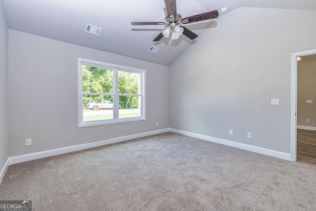 unfurnished room with lofted ceiling, ceiling fan, and carpet flooring