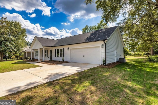 view of front facade featuring a garage, central AC unit, and a front lawn