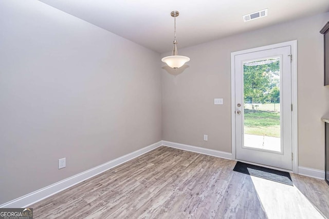 doorway to outside with light hardwood / wood-style floors and a healthy amount of sunlight