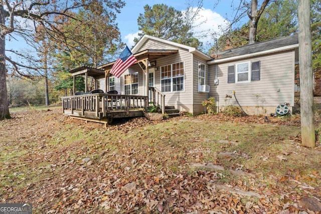 view of front of home with cooling unit and a deck