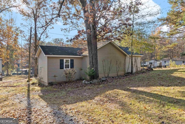 view of home's exterior featuring a yard