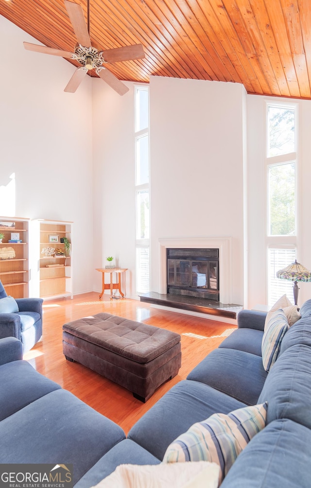 living room with wooden ceiling and light wood-type flooring