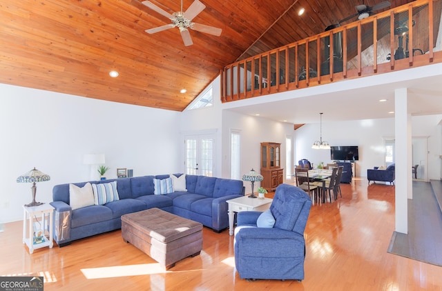 living room with a healthy amount of sunlight, high vaulted ceiling, wooden ceiling, and ceiling fan