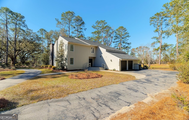 view of side of property with a garage and central AC