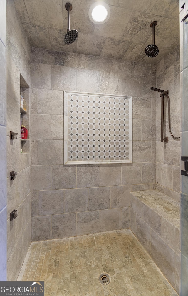 bathroom with a tile shower