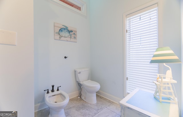 bathroom featuring a bidet, tile patterned floors, and toilet