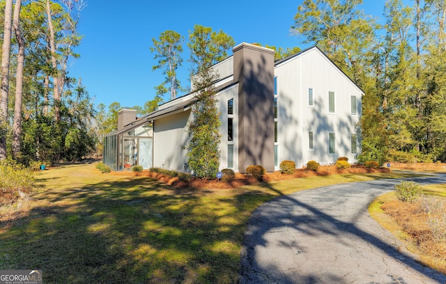 view of property exterior with a yard