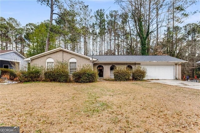 single story home with a garage and a front lawn