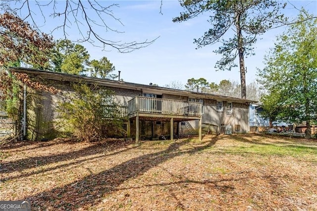 back of house featuring a yard and a deck