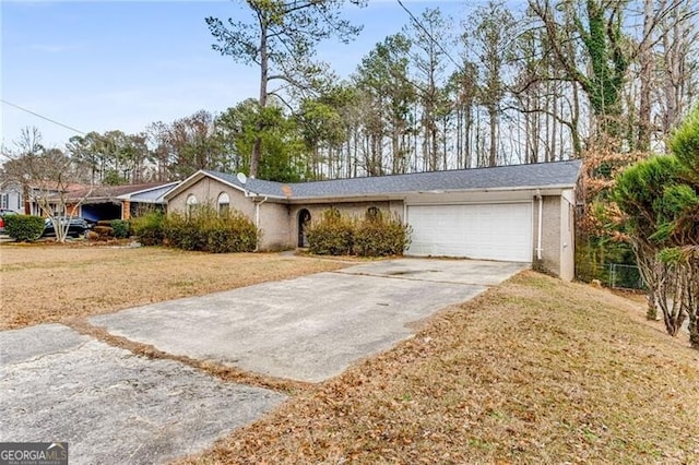 ranch-style house featuring a garage and a front yard