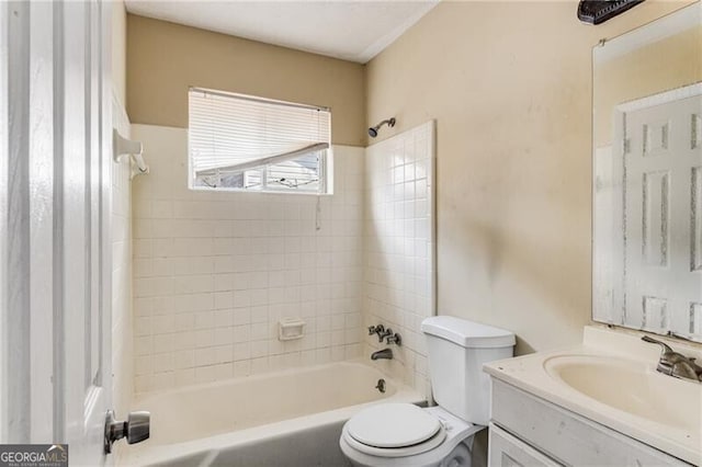 full bathroom with tiled shower / bath combo, vanity, and toilet