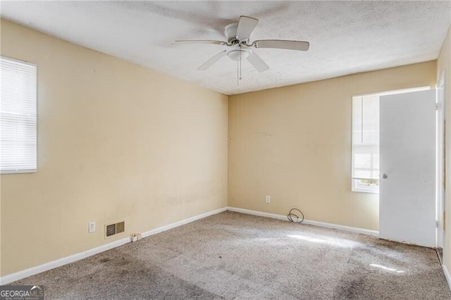 unfurnished room featuring ceiling fan and carpet floors