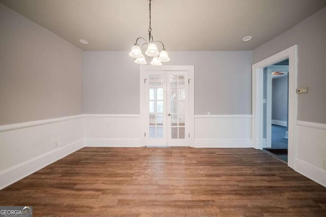 3693 Aldea Dr, Decatur, GA 30032 - unfurnished dining area featuring french doors, a chandelier, and hardwood / wood-style floors