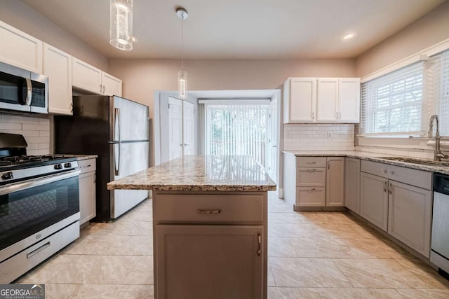 3693 Aldea Dr, Decatur, GA 30032 - kitchen with stainless steel appliances, tasteful backsplash, sink, and white cabinets