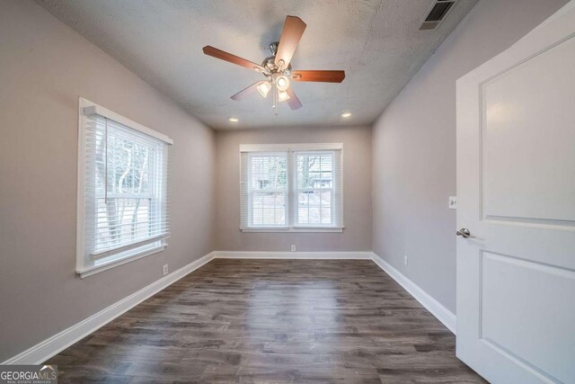 3693 Aldea Dr, Decatur, GA 30032 - unfurnished room featuring a textured ceiling, dark wood-type flooring, and a healthy amount of sunlight