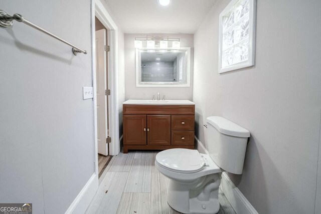 3693 Aldea Dr, Decatur, GA 30032 - bathroom featuring vanity, toilet, hardwood / wood-style floors, and a shower