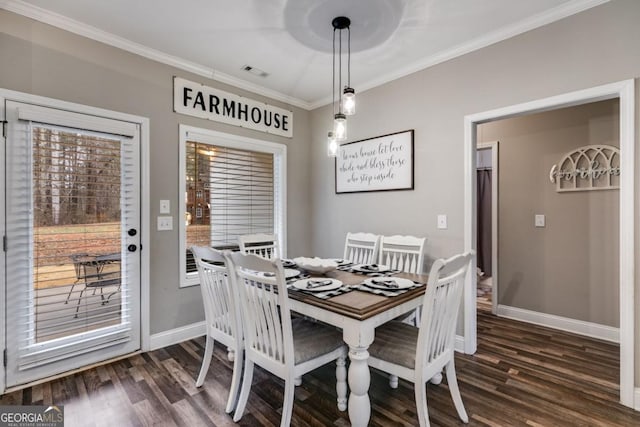 dining space with dark wood-type flooring and ornamental molding