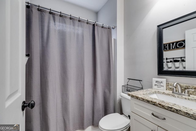 bathroom featuring vanity, toilet, and a shower with shower curtain