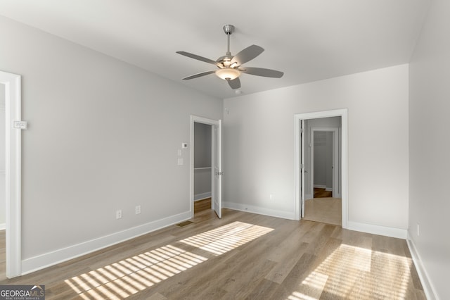 unfurnished bedroom featuring hardwood / wood-style floors and ceiling fan