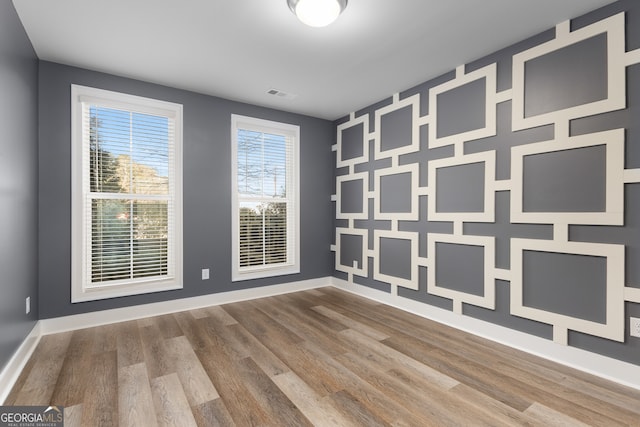 spare room with wood-type flooring