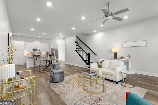 living room with ceiling fan and light wood-type flooring