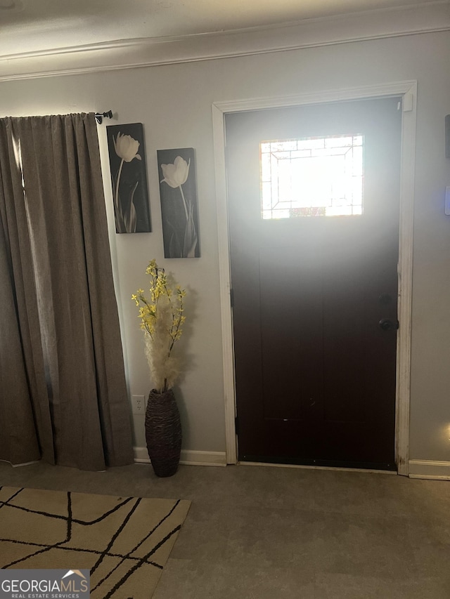 view of carpeted foyer entrance