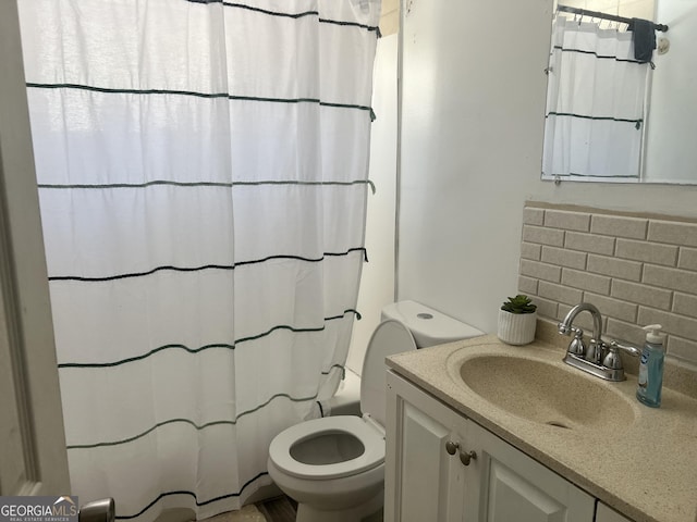 full bathroom featuring shower / bath combination with curtain, vanity, backsplash, and toilet