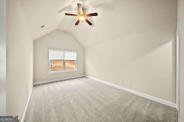 interior space with ceiling fan, lofted ceiling, and light carpet