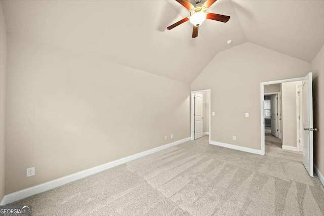 unfurnished bedroom with lofted ceiling, light colored carpet, and ceiling fan