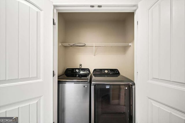 washroom featuring washer and dryer