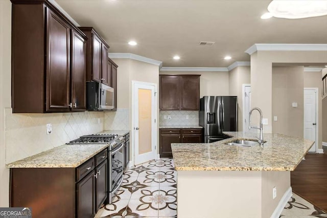 kitchen with sink, decorative backsplash, ornamental molding, stainless steel appliances, and light stone countertops