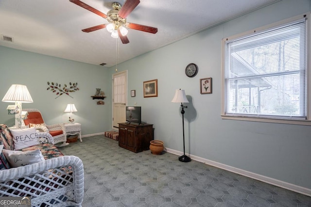 living area featuring ceiling fan